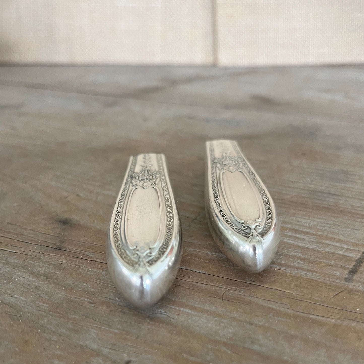 Detail view of Triumph pattern 1930s silverplate magnetic bud vase showing smooth buffed finish - knife vase - handcrafted from upcycled vintage silverware - Laughing Frog Studio