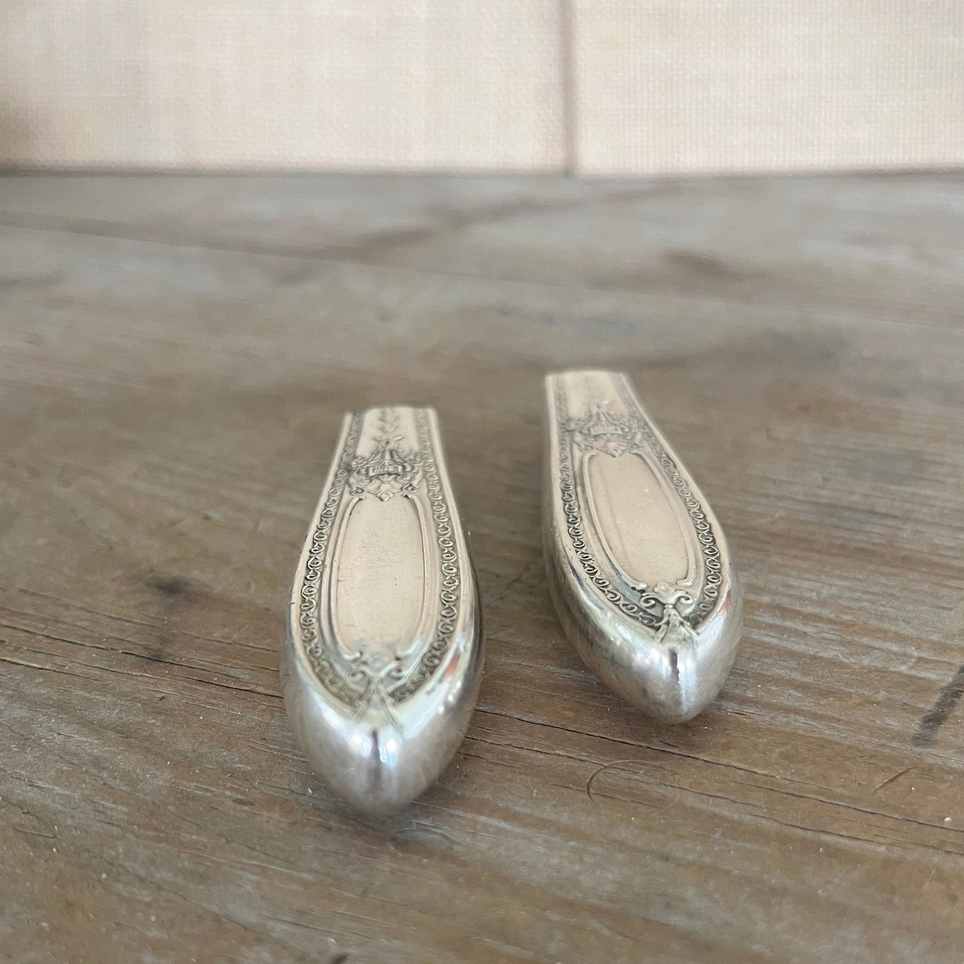 Detail view of Triumph pattern 1930s silverplate magnetic bud vase showing smooth buffed finish - knife vase - handcrafted from upcycled vintage silverware - Laughing Frog Studio