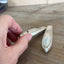 Side angle of Triumph pattern knife vase showing decorative detail and magnetic base for fridge display - handcrafted from upcycled vintage silverware - Laughing Frog Studio