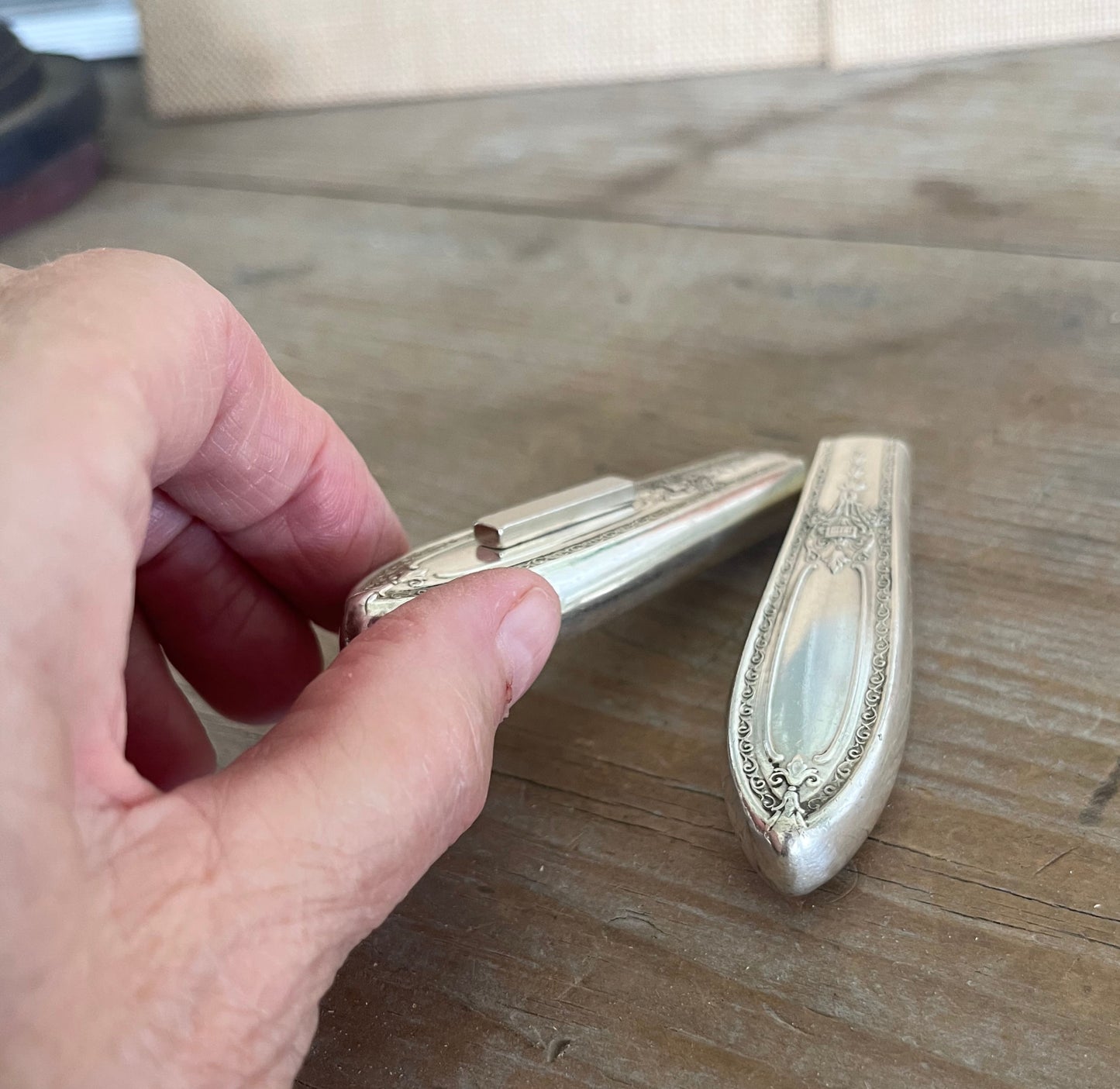 Side angle of Triumph pattern knife vase showing decorative detail and magnetic base for fridge display - handcrafted from upcycled vintage silverware - Laughing Frog Studio