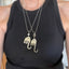 Two fork elephant necklaces worn together on model showing Hamsa and pearl bead styles layered - handcrafted from upcycled vintage silverware - Laughing Frog Studio