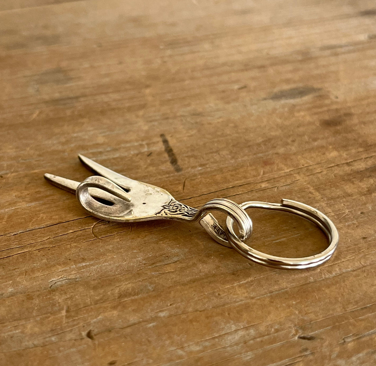 Upcycled fork peace sign keychain side 
view - handcrafted from upcycled vintage silverware - Laughing Frog Studio