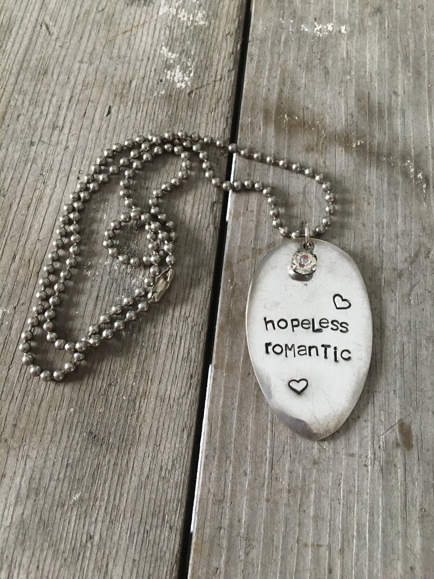 HOPELESS ROMANTIC stamped spoon necklace showing hand-stamped lettering and rhinestone detail, layerable boho-gypsy romance jewelry, 23-inch chain