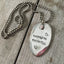Close-up of HOPELESS ROMANTIC hand-stamped spoon pendant with decorative jewel showing love-inspired message on reclaimed vintage silverware