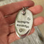 HOPELESS ROMANTIC hand-stamped spoon necklace with jewel held in hand for scale showing one-of-a-kind romantic design on vintage ball chain