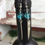 Fork Earrings from Upcycled Serving Fork Tines Shown Hanging on a wine Bottle