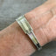 1881 Rogers Grecian pattern spoon cuff bracelet worn on wrist - handcrafted from upcycled vintage silverware - Laughing Frog Studio