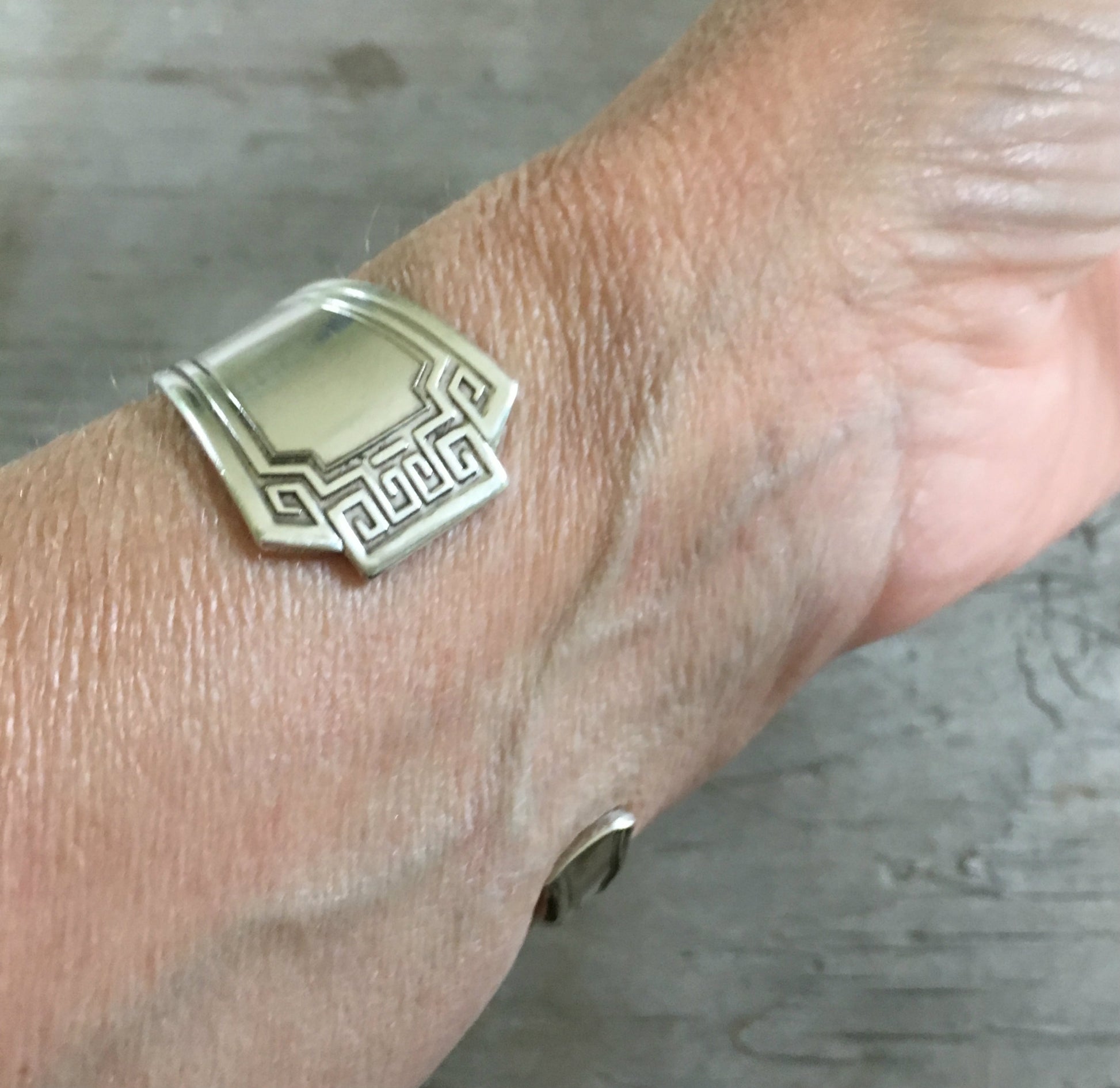 1881 Rogers Grecian silverplate cuff bracelet angled view on model - handcrafted from upcycled vintage silverware - Laughing Frog Studio