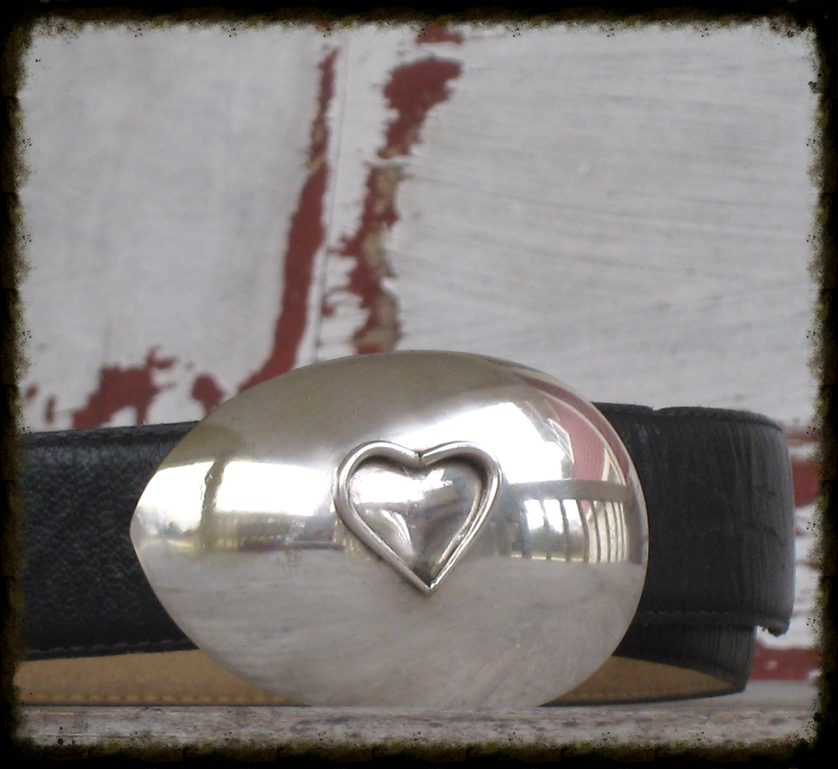 Close-up of fork-tine heart detail on casserole spoon belt buckle showing artisan craftsmanship and reclaimed silverware, one-of-a-kind design