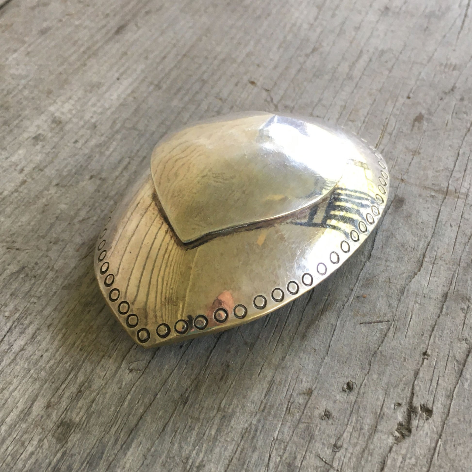 Artisan heart spoon belt buckle detail showing reclaimed silverware craftsmanship