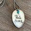 Close-up of IT'S A TEXAS THANG hand-stamped spoon pendant with decorative beads showing Texas pride message on reclaimed vintage silverware, 18-inch chain, one-of-a-kind