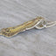 Close-up of Oxford spoon handle necklace showing self-loop hanging device and earth tone bead accents on 19-inch chain, upcycled antique silverware