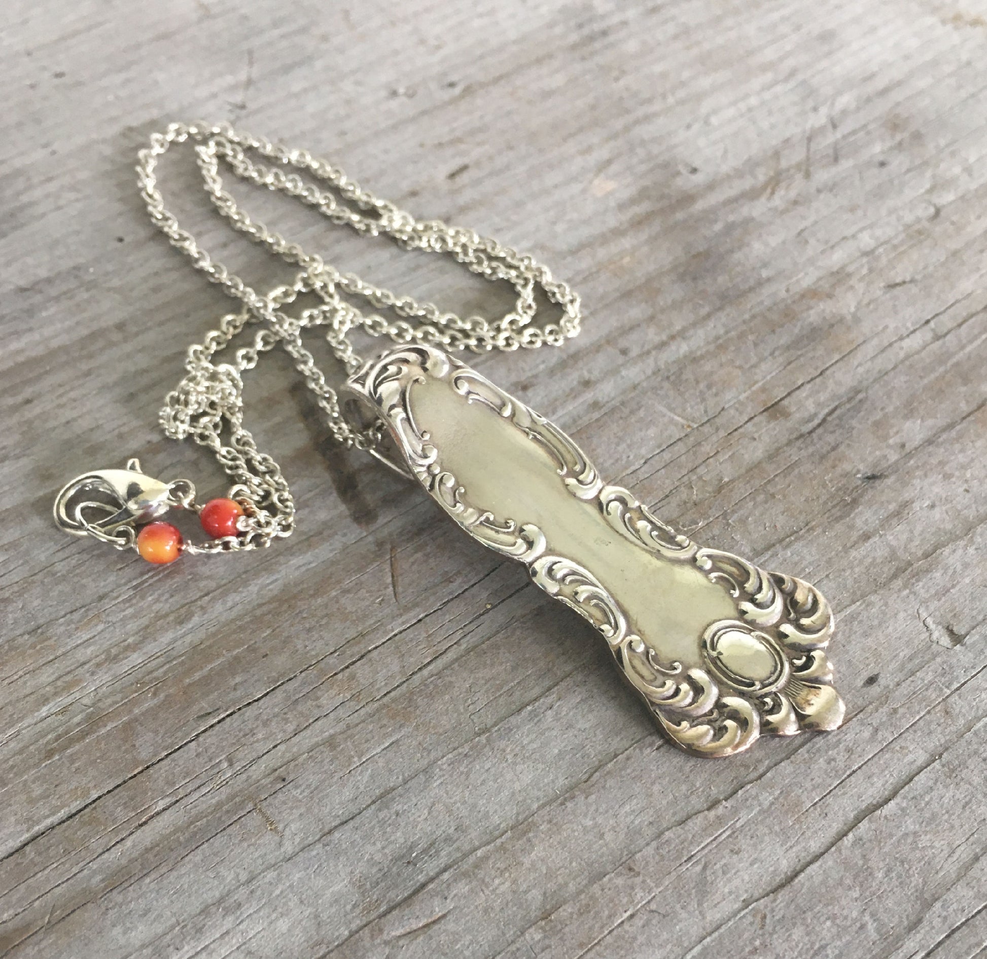 Side view of Oxford silverplate spoon handle necklace showing symmetrical scroll and curl design detail, vintage William Rogers 1901 jewelry