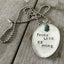 Close-up of THINK LESS BE MORE hand-stamped spoon pendant with turquoise bead showing inspirational motto on reclaimed vintage silverware