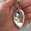 THINK LESS BE MORE hand-stamped spoon necklace with turquoise stone bead held in hand for scale, layerable gypsy style motivational jewelry