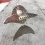 Close-up detail of articulated fish pendant made from upcycled vintage spoons with cultured pearl - handcrafted artisan necklace