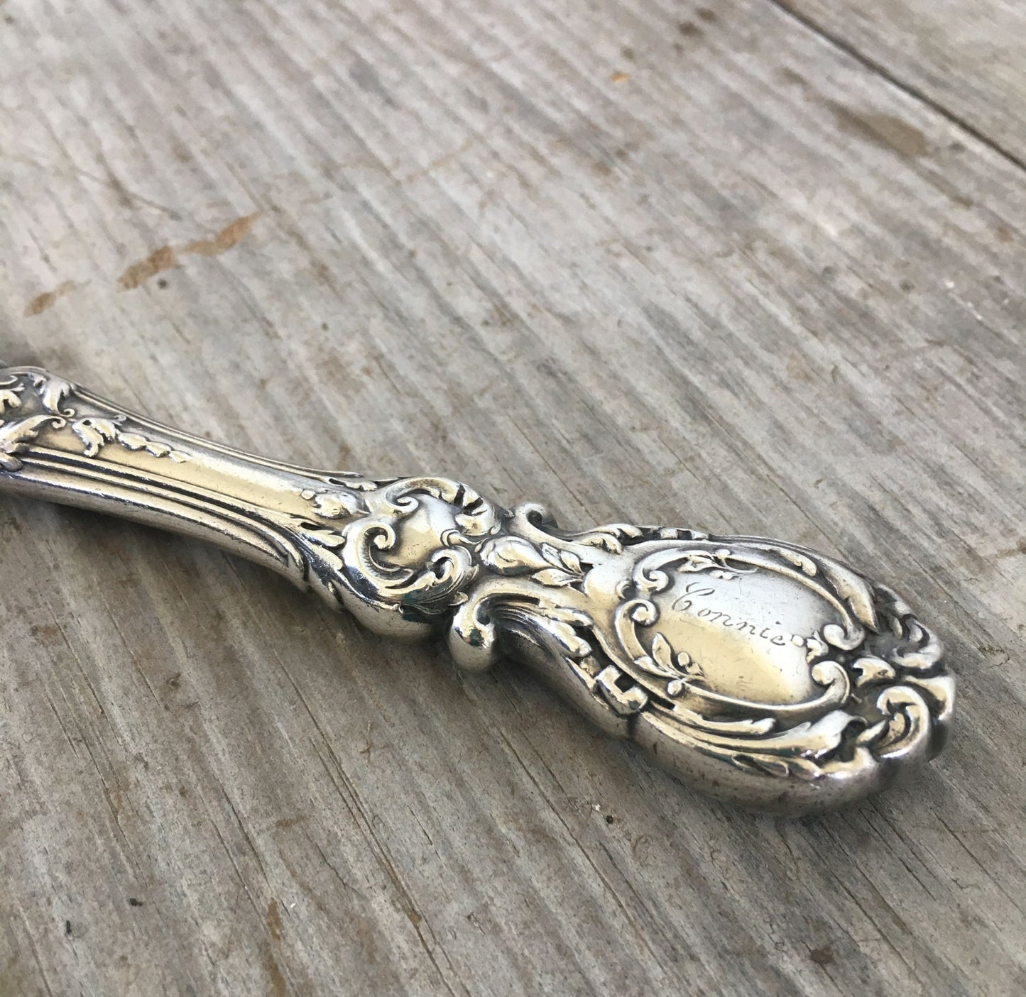 Detail of Connie monogram and Renaissance-era artistry on vintage Reed & Barton Francis I sterling knife