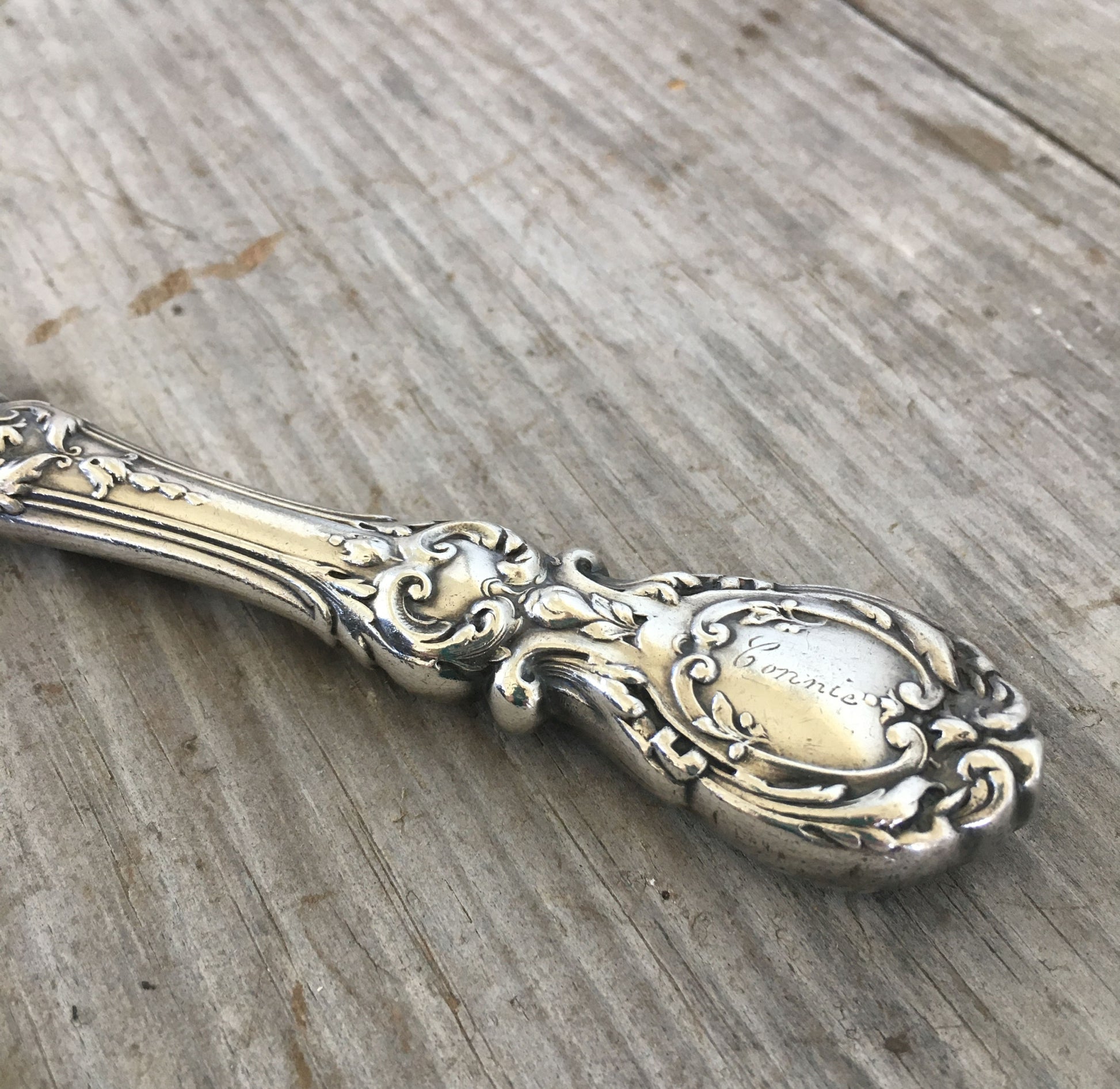 Detail of Connie monogram and Renaissance-era artistry on vintage Reed & Barton Francis I sterling knife
