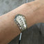 Algonquin Remember Stamped spoon cuff bracelet shown on model's arm