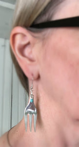 Cocktail fork earrings with teal green beads shown on model
