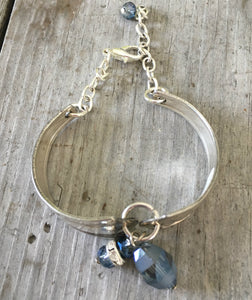 View from above a handmade Spoon link bracelet with smoky blue glass beads
