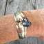 Silveware handle link bracelet with smoky blue glass beads shown on model's arm