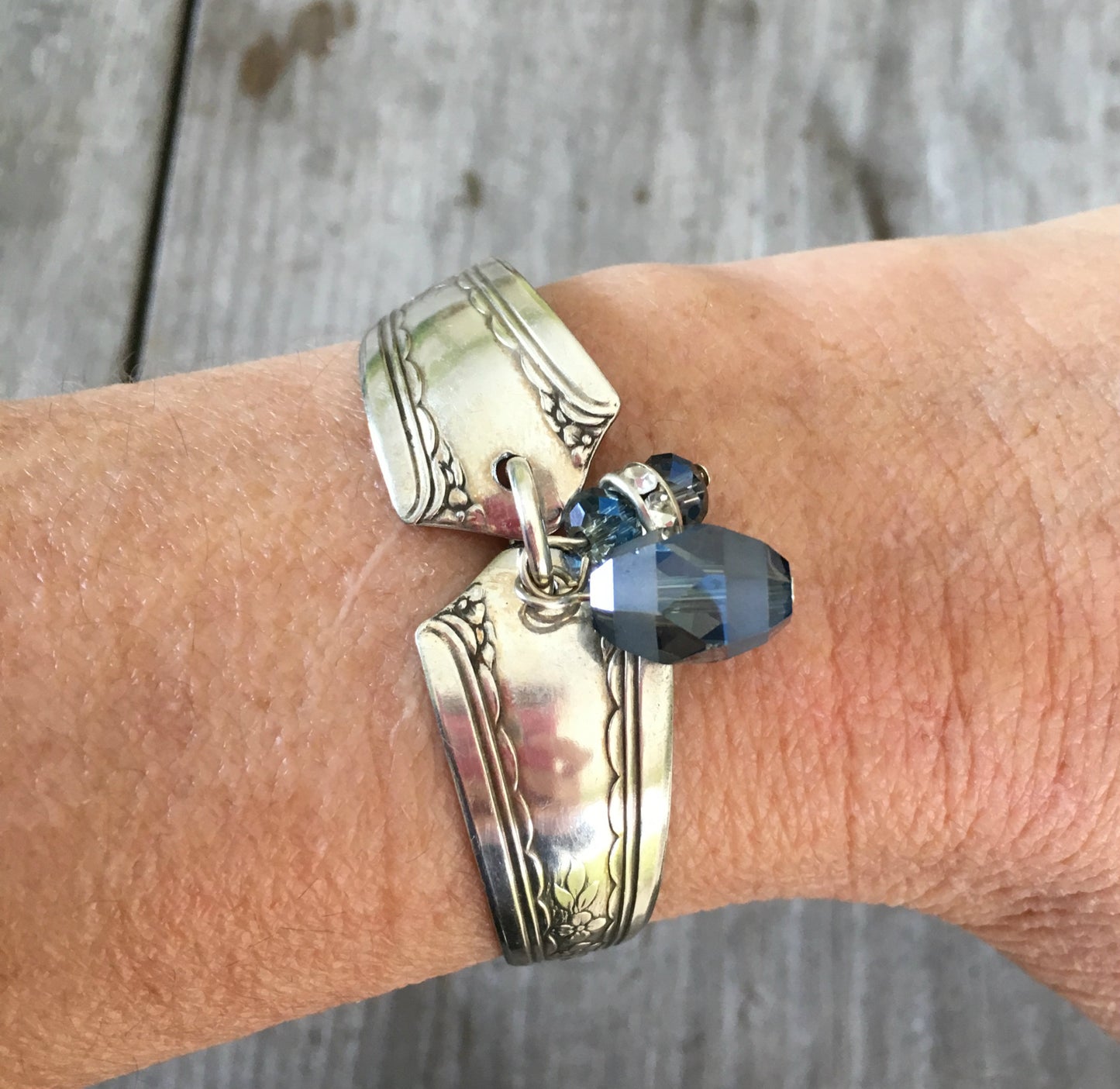 Silveware handle link bracelet with smoky blue glass beads shown on model's arm