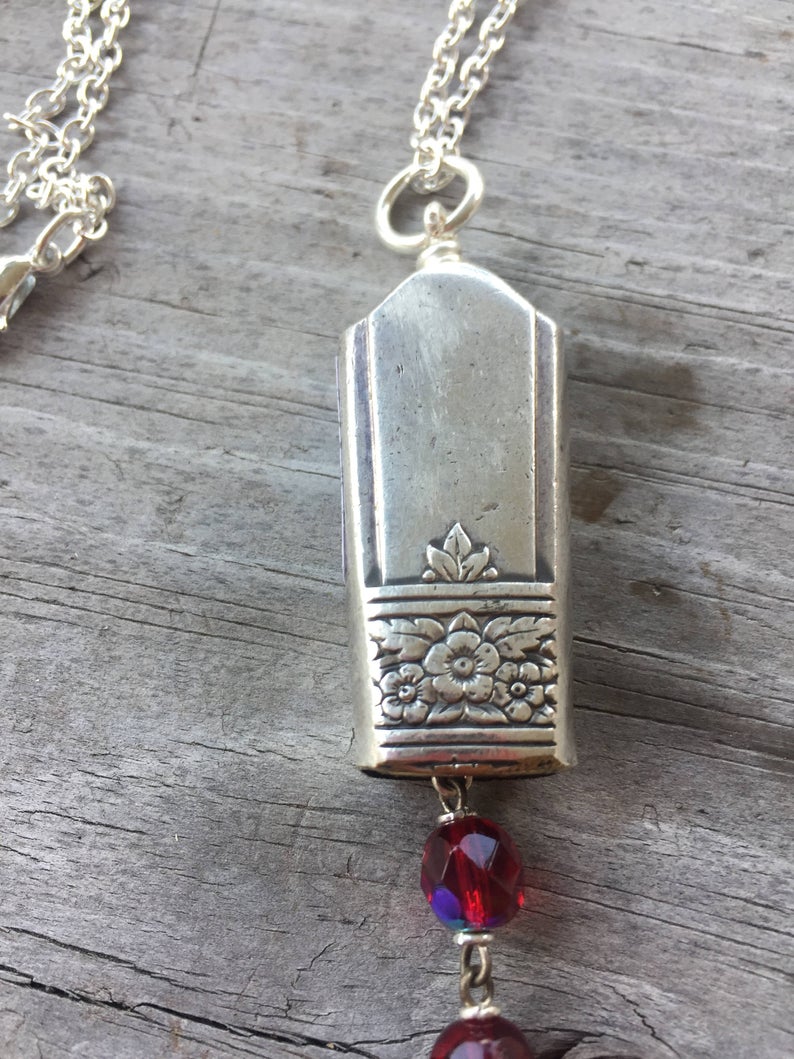 Close up of Bell Necklace made from upcycled silverware knife