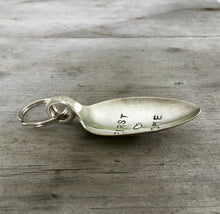 Side view of Spoon keychain hand stamped with FIRST HOME and a heart