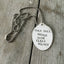 Close-up of ONLY DULL PEOPLE HAVE CLEAN HOUSES hand-stamped spoon pendant showing humorous message on reclaimed vintage silverware, 19-inch chain
