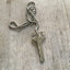 Born in the USA Stamped Key Giving Key Necklace