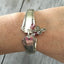 Del Mar Spoon Link Bracelet with pink beads an pewter cross charm shown on model's arm