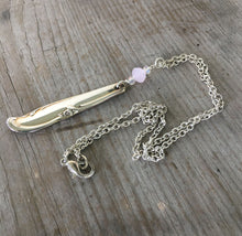 necklace made from upcycled spoon handle and an opaque pink bead