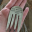 Handmade upcycled fork bookmark shown in hand for size and scale