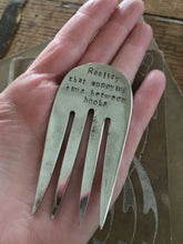 Handmade upcycled fork bookmark shown in hand for size and scale