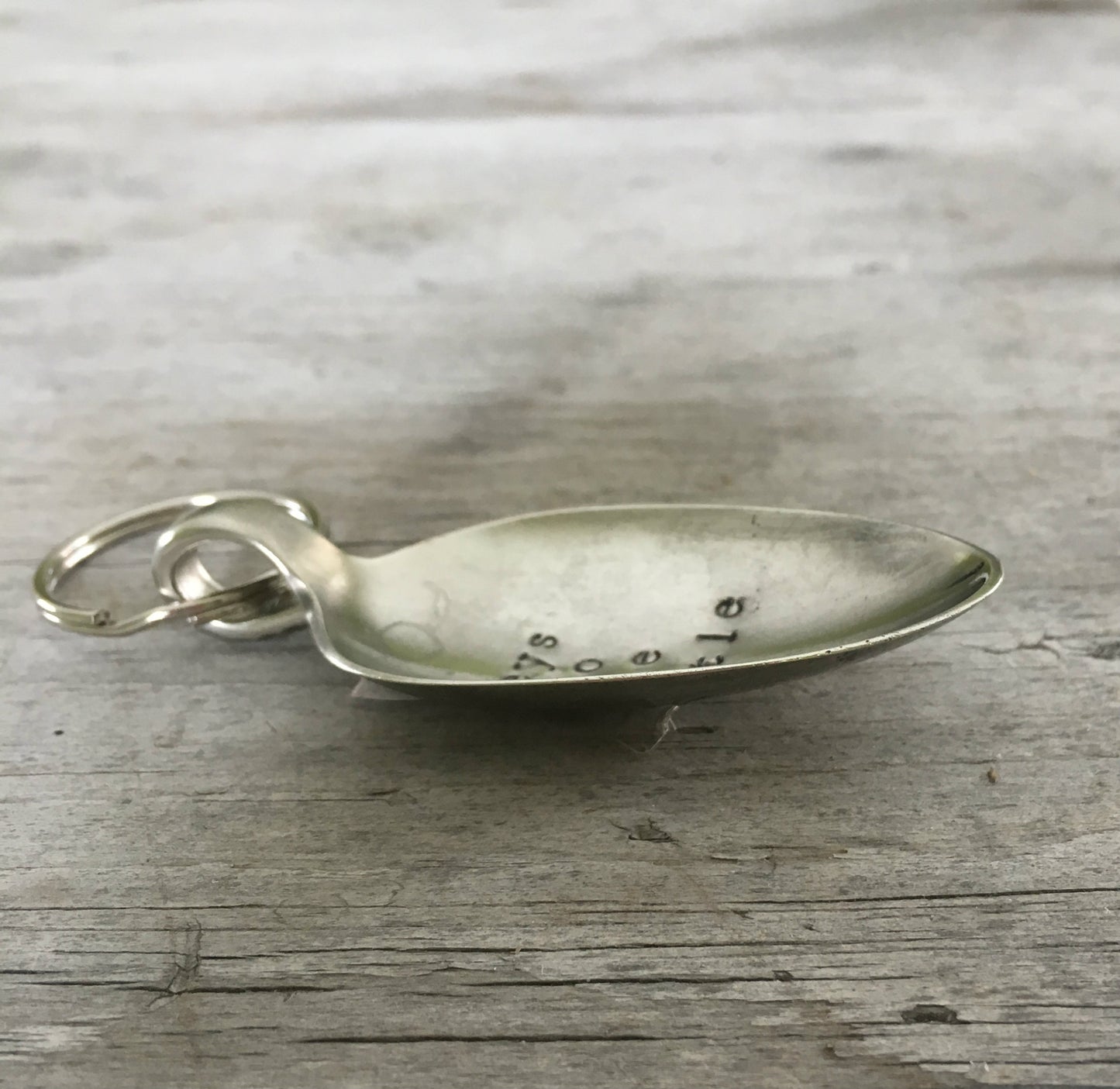 Side view of Keys To The Castle hand-stamped spoon keychain showing vintage silverware patina and detail