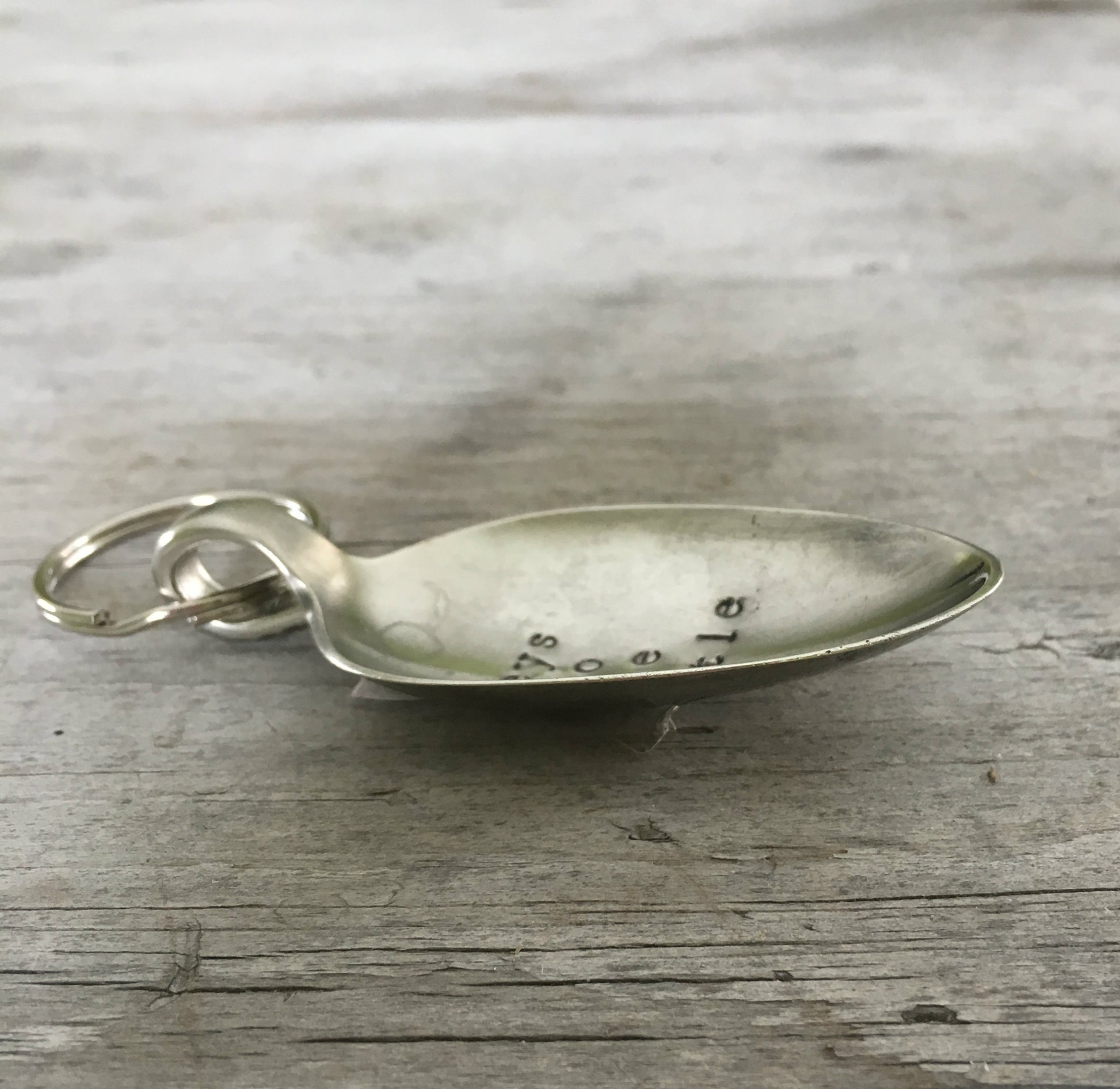 Side view of Keys To The Castle hand-stamped spoon keychain showing vintage silverware patina and detail