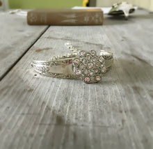 Front view of Bracelet made from two Camelia spoon handles and a flower shaped rhinestone button