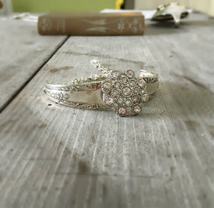 Front view of Bracelet made from two Camelia spoon handles and a flower shaped rhinestone button
