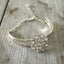 Camelia spoon handle link bracelet and a flower shaped rhinestone button and crystal bead