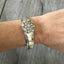 Camelia spoon bracelet with flower shaped rhinestone button shown on model's arm