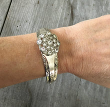 Camelia spoon bracelet with flower shaped rhinestone button shown on model's arm