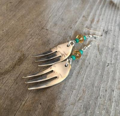 Side view of fork tine earrings showing scalloped edge and curvaceous center prong with lavender beads, 3 inches long