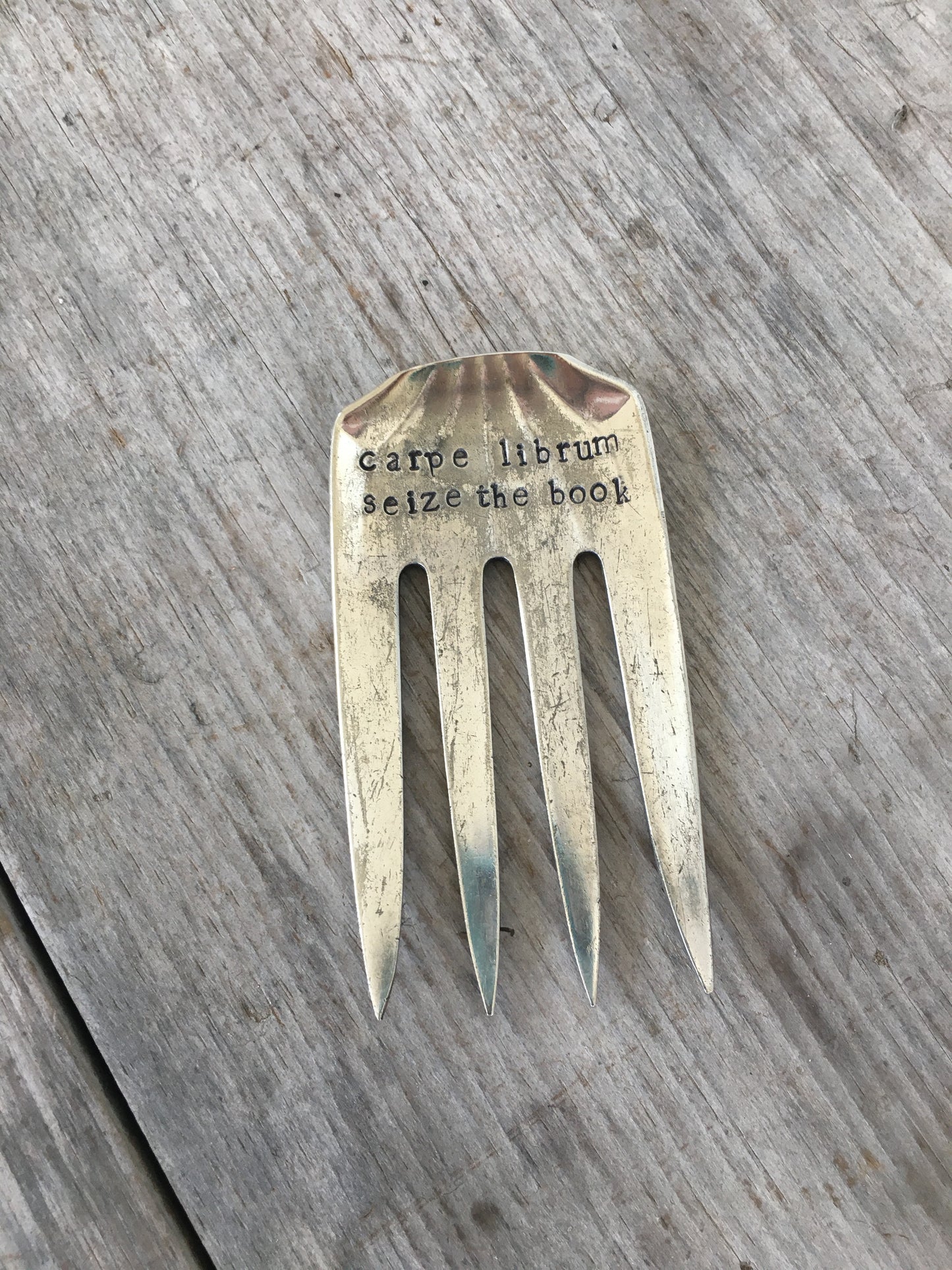 Handcrafted fork bookmark stamped CARPE LIBRUM showing vintage pattern detail