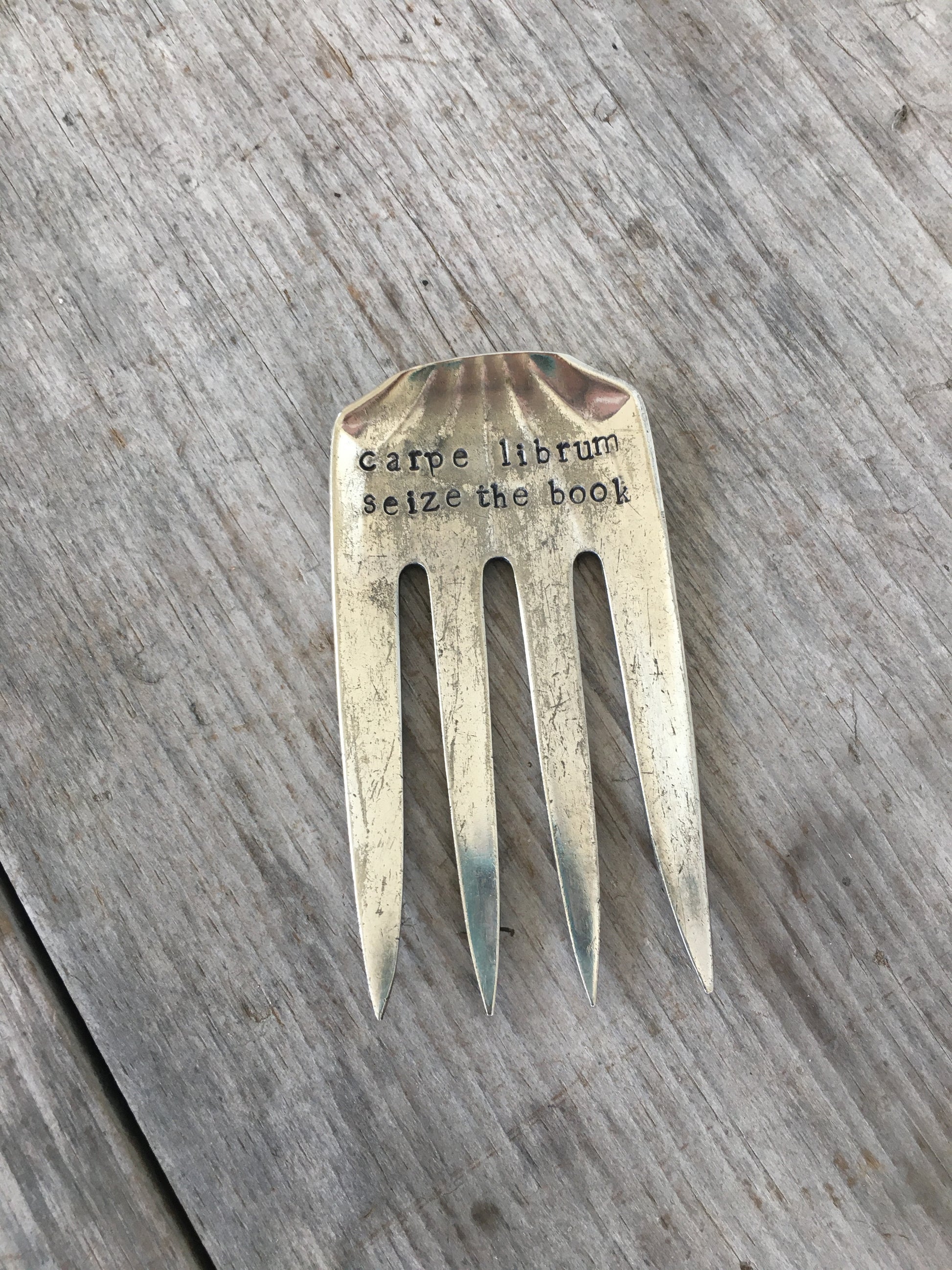 Handcrafted fork bookmark stamped CARPE LIBRUM showing vintage pattern detail