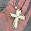 Vintage 1923 William Rogers Mayfair spoon handles transformed into artisan cross pendant shown in hand for scale