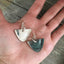 Spoon earrings with modern vibe shown in hand for scale