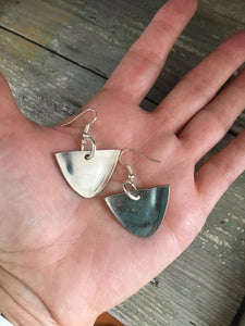 Spoon earrings with modern vibe shown in hand for scale