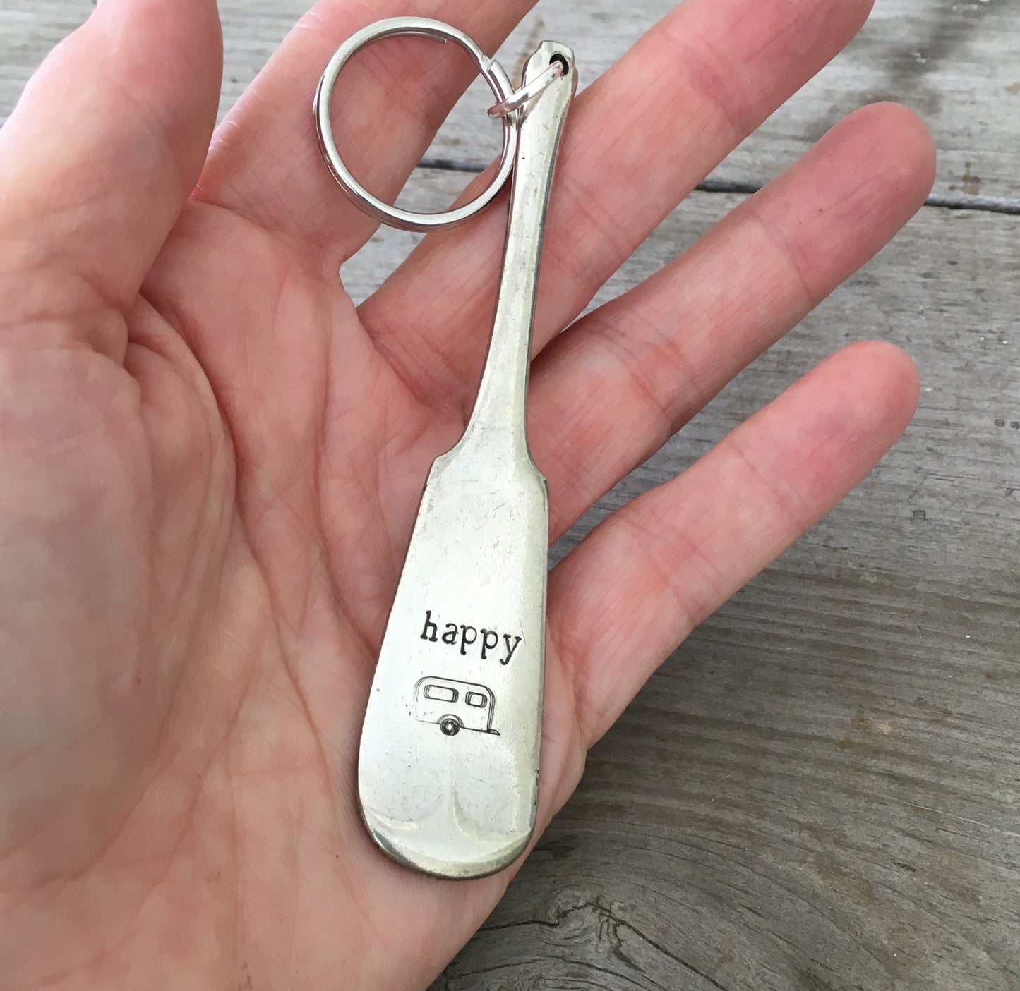 Close-up of Happy Camper hand-stamped lettering on vintage spoon keychain upcycled silverware detail