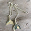 Handmade upcycled silverware spoon necklaces in the shape of a tail fin